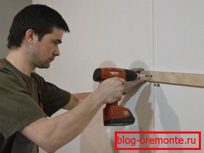 En la foto - instalación de listones de madera para la instalación de paneles de pared.