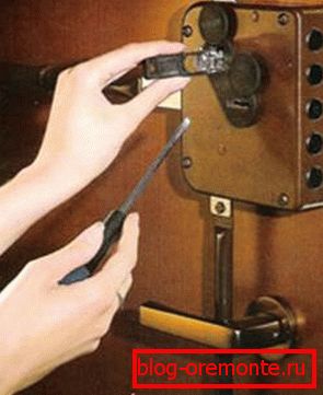 Instalación de una cerradura en una puerta de metal.